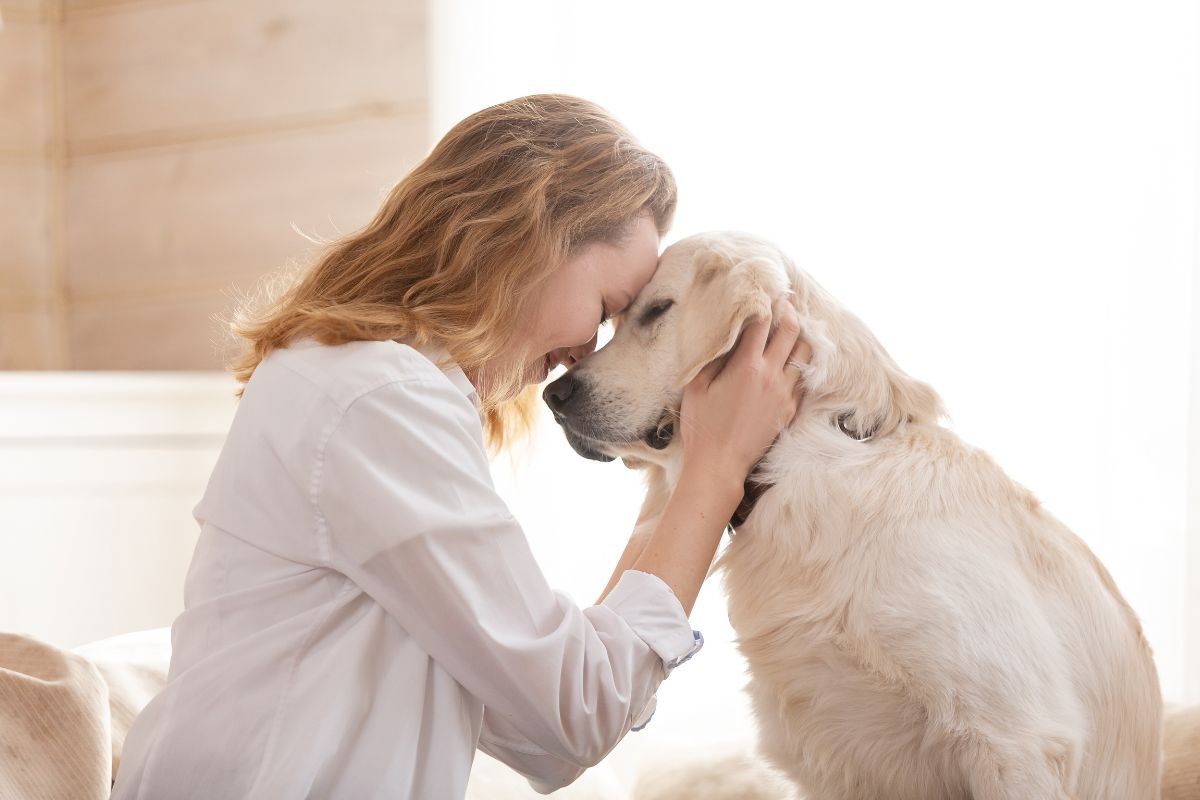 Woman embraces her new dog amid first day challenges.