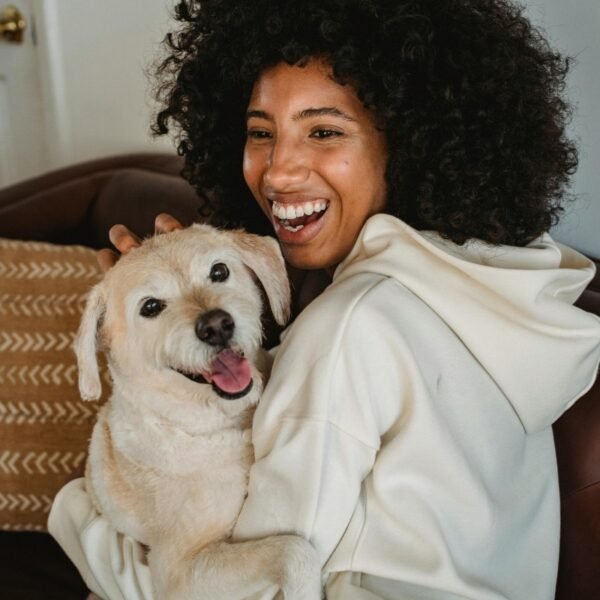 A young woman embraces her new dog.